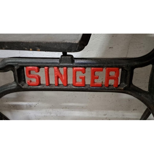 78 - Antique Singer cast iron sewing machine base, featuring intricate design and original red detailing.