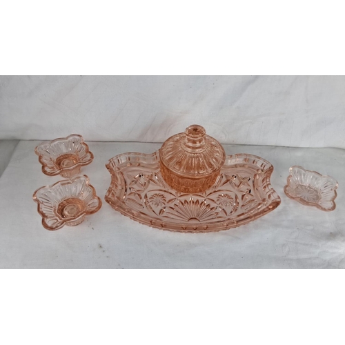 80 - Condiment set in pink depression glass, featuring a lidded jar and three matching dishes on a floral... 