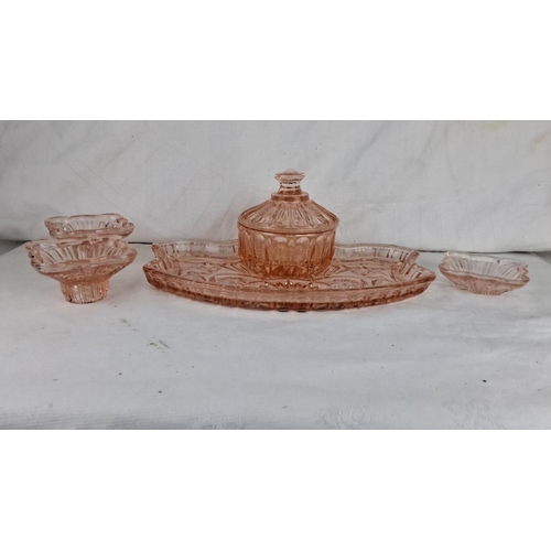 80 - Condiment set in pink depression glass, featuring a lidded jar and three matching dishes on a floral... 