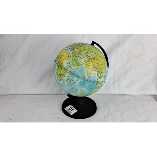 91 - Desktop spinning globe, featuring a detailed map on a black base.