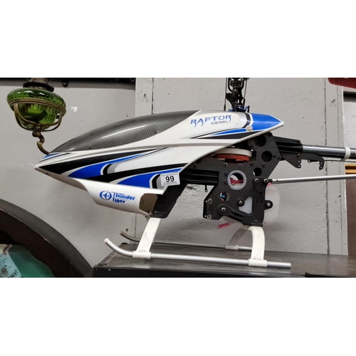 99 - Thunder Tiger Raptor model helicopter, featuring distinctive blue and white design, with visible mec... 