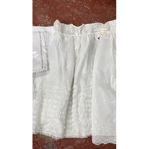 218 - Two 1960's christening robes, a Broderie Pearse pram set and a Victorian under slip.