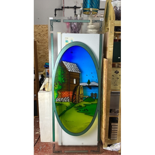 220 - Large decorative stained glass panel features a scenic watermill landscape, accented with geometric ... 