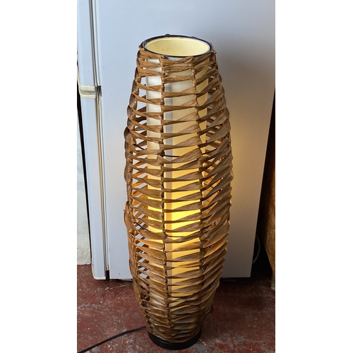 221 - Contemporary wicker floor lamp with woven design and inner light diffuser.