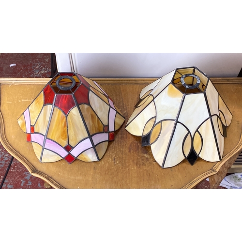 223 - Pair of stained glass lamp shades with geometric Art Deco design, featuring hues of red, pink, and a... 