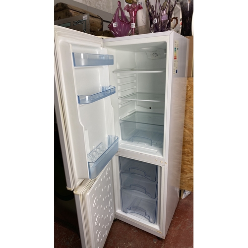 224 - Logik refrigerator-freezer, white finish, with internal storage shelves. Classic design.