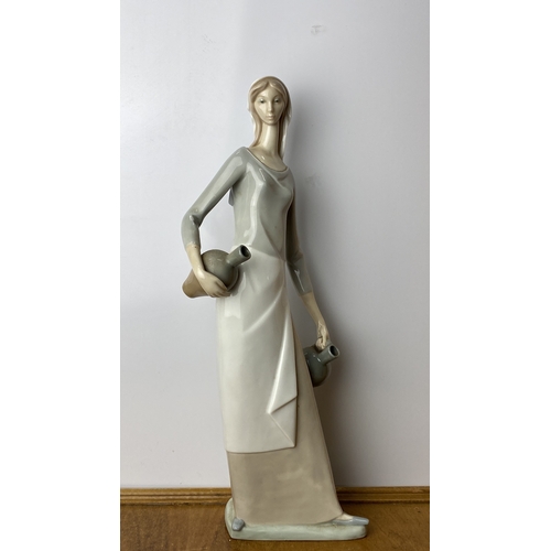 228 - Nao Porcelain figurine depicts an elegant woman in Art Deco style, marked on base 