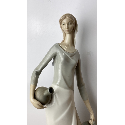 228 - Nao Porcelain figurine depicts an elegant woman in Art Deco style, marked on base 