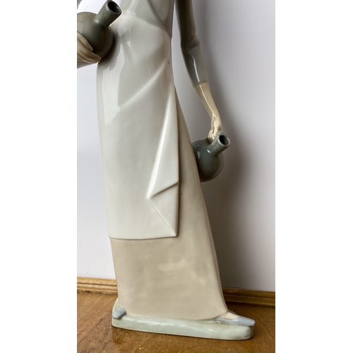 228 - Nao Porcelain figurine depicts an elegant woman in Art Deco style, marked on base 