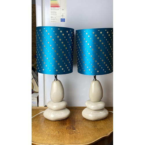 229 - Pair of modern table lamps with cream stone-like bases and vibrant blue shades featuring gold polka ... 