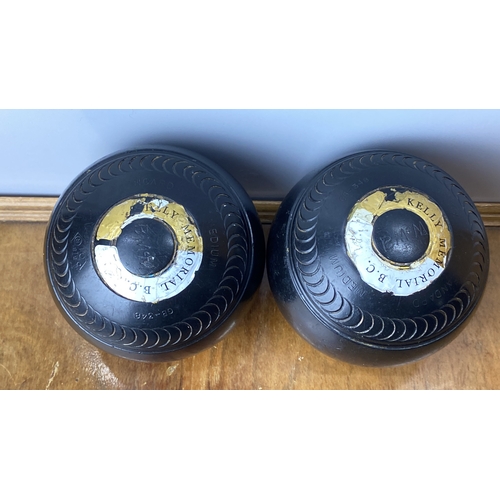 231 - Pair of vintage lawn bowls featuring 