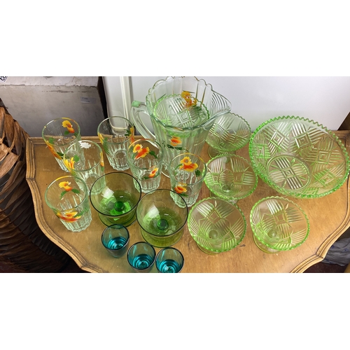 240 - Collection of vintage glassware features a floral-etched water pitcher, matching tumblers, green gla... 