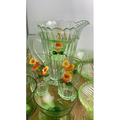 240 - Collection of vintage glassware features a floral-etched water pitcher, matching tumblers, green gla... 