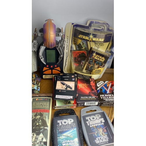 280 - Star Wars collectible lot featuring books, Quiz Wiz games, trading cards, and a Star Wars-themed ele... 