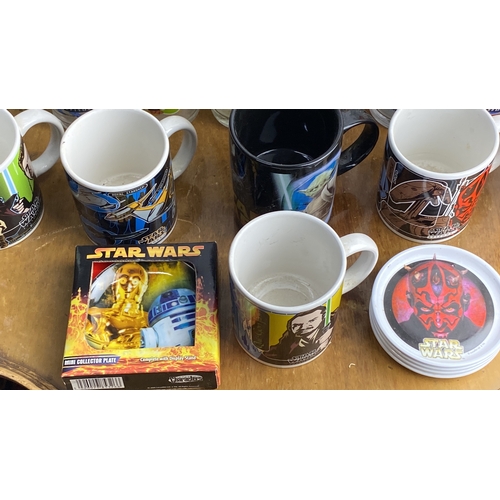 283 - Collection of Star Wars themed mugs and glasses, featuring various characters and designs, alongside... 