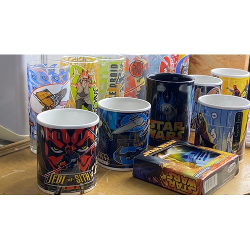 283 - Collection of Star Wars themed mugs and glasses, featuring various characters and designs, alongside... 