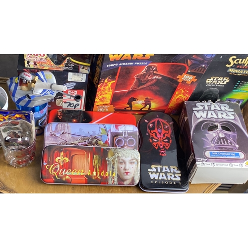 292 - Mixed lot including Star Wars themed puzzles, trivia game, stickers, and collectible tins. Includes ... 