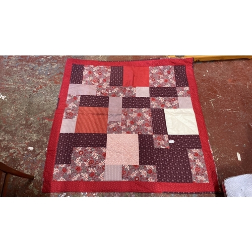 217 - Patchwork quilt features floral and geometric patterns in red and burgundy tones. Reversible with so... 