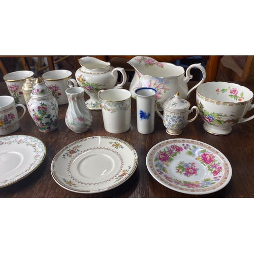 307 - Porcelain tea set with floral patterns includes cups, saucers, creamers, and sugar bowls. Various st... 