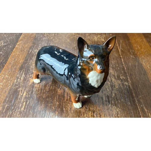 320 - Beswick Hand-painted ceramic figurine of a standing Corgi dog, with a glossy finish and detailed fea... 