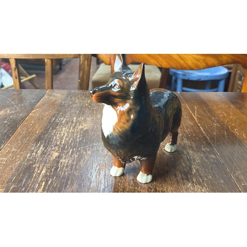 320 - Beswick Hand-painted ceramic figurine of a standing Corgi dog, with a glossy finish and detailed fea... 