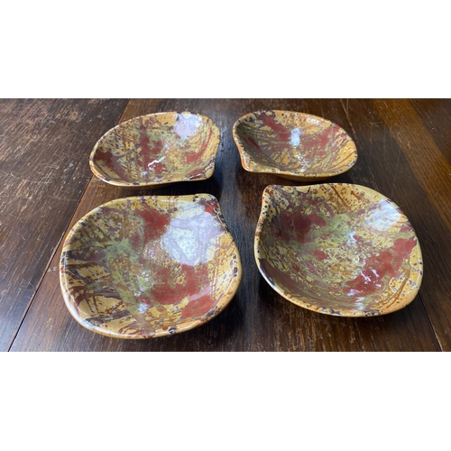 323 - Set of four glazed ceramic dishes with abstract splatter design. Artist's mark on the base.