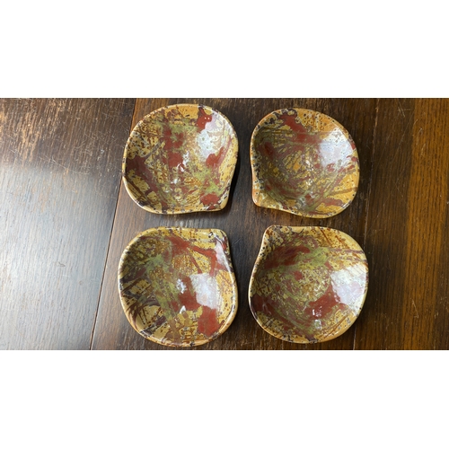 323 - Set of four glazed ceramic dishes with abstract splatter design. Artist's mark on the base.