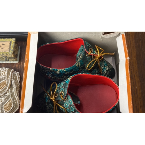 332 - Beaded clutch, decorative folding fan in box, and patterned fabric shoes in original packaging.