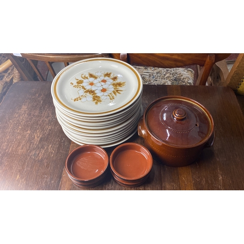 339 - Stoneware dinner set features floral patterned plates, a large covered casserole, and matching ramek... 