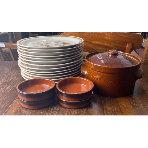 339 - Stoneware dinner set features floral patterned plates, a large covered casserole, and matching ramek... 