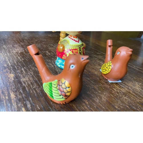 350 - Hand-painted wooden Russian figurine set features a Matryoshka doll and two bird whistles with vibra... 