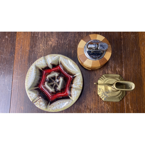 351 - Mid-Century modern pottery ashtray, teak and metal table lighter, and brass candlestick.