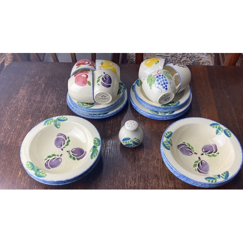 354 - Poole Pottery 'Dorset Fruits' tableware set features vibrant fruit motifs, England.