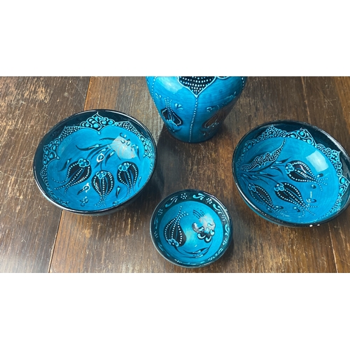 355 - Turkish-style ceramic bowl set features intricate blue designs. Signed by artist on base.