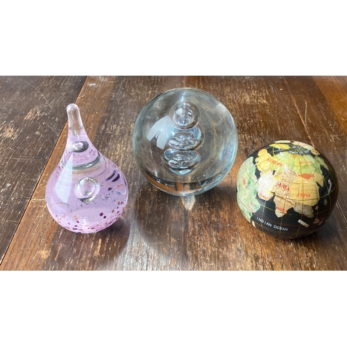 365 - Set of three decorative glass paperweights: a pink teardrop, a clear bubble-infused sphere, and a mi... 