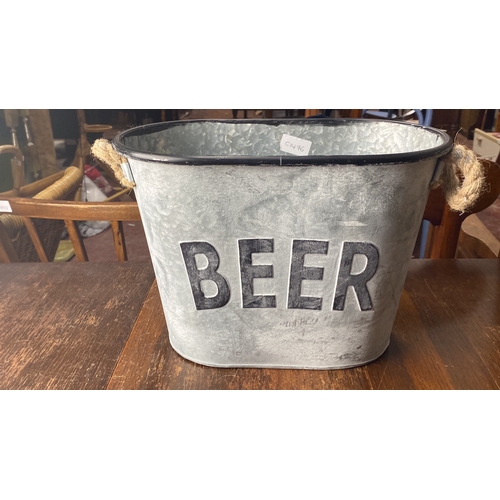 368 - Galvanized metal beer bucket with rope handles. Features embossed 