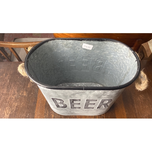 368 - Galvanized metal beer bucket with rope handles. Features embossed 