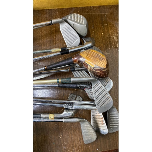 382 - Mixed lot of vintage golf clubs, featuring a variety of irons and a wood driver, with steel shafts a... 