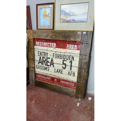 388 - Wooden sign displaying “Restricted Area 51” with barbed wire detailing. Rustic, vintage aesthetic re... 