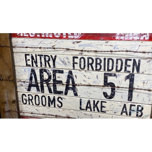 388 - Wooden sign displaying “Restricted Area 51” with barbed wire detailing. Rustic, vintage aesthetic re... 