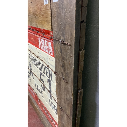 388 - Wooden sign displaying “Restricted Area 51” with barbed wire detailing. Rustic, vintage aesthetic re... 