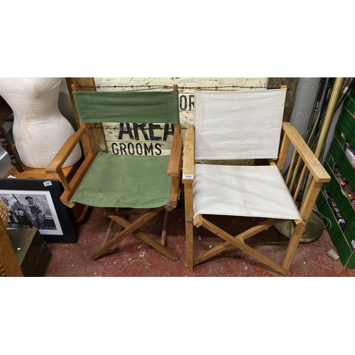 389 - 2 vintage directors' chairs with wooden frames and canvas seats with green and white covers.