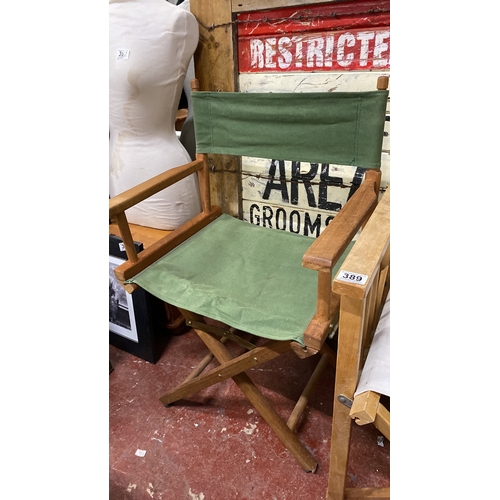 389 - 2 vintage directors' chairs with wooden frames and canvas seats with green and white covers.