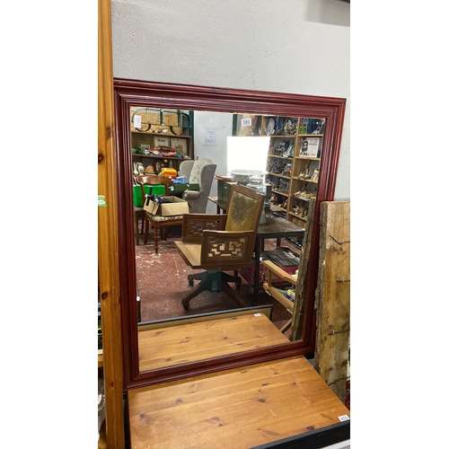 399 - Rectangular wall mirror with a red wooden frame, featuring a simple yet elegant design.