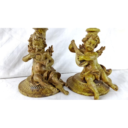 101 - Pair of vintage cherub candlesticks, intricately detailed, featuring musical and playful figures, co... 