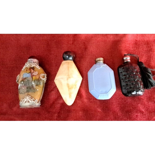 107 - Four decorative glass and porcelain snuff bottles, featuring intricate designs and diverse materials... 