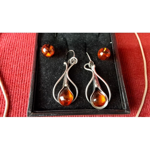 122 - Sterling silver jewellery set with amber gemstones, including a pendant necklace and matching earrin... 