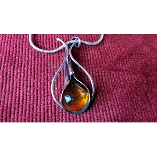 122 - Sterling silver jewellery set with amber gemstones, including a pendant necklace and matching earrin... 