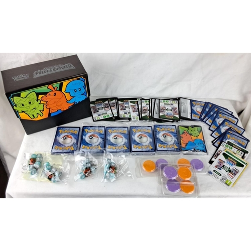 138 - Collection of Pokémon cards, to include booster packs, cards, dice, and counters in vibrant thematic... 