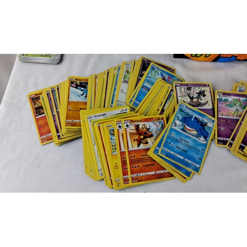 139 - Large assortment of Pokémon trading cards, featuring collectible tins and boxes for organization. In... 